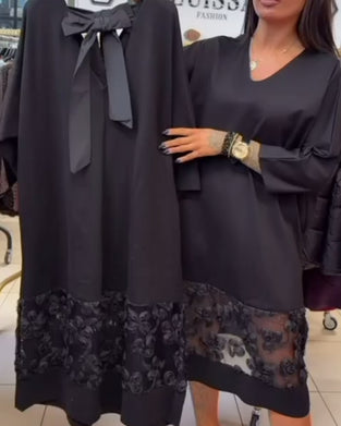 Stilvolles Kleid mit Schleife auf dem Rücken und V-Ausschnitt