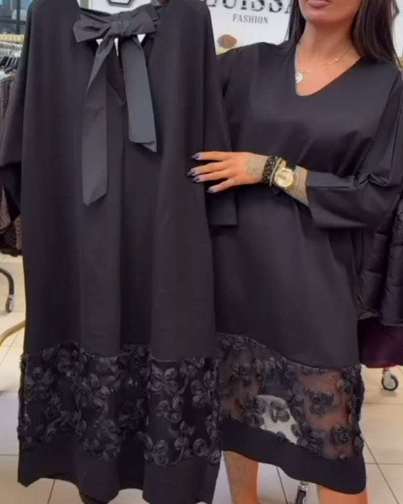 Stilvolles Kleid mit Schleife auf dem Rücken und V-Ausschnitt