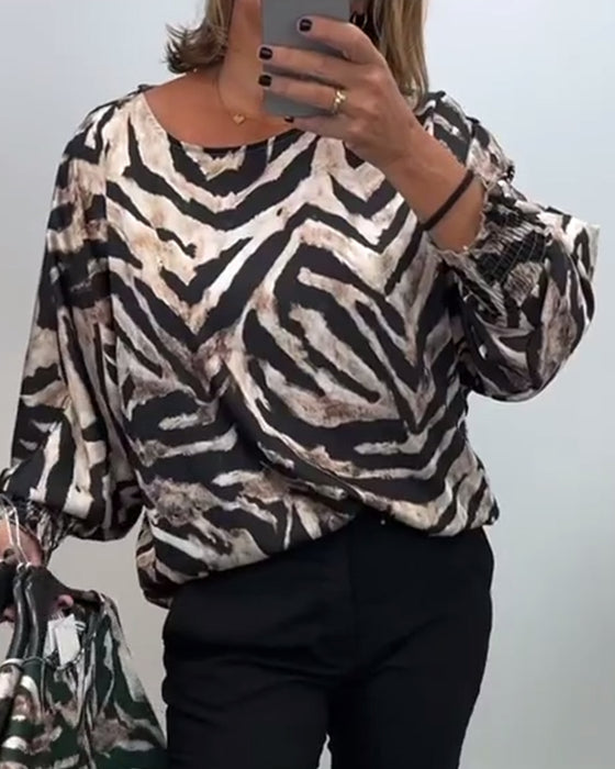 Lässige bluse mit rundhalsausschnitt und laternenärmeln im zebra-print