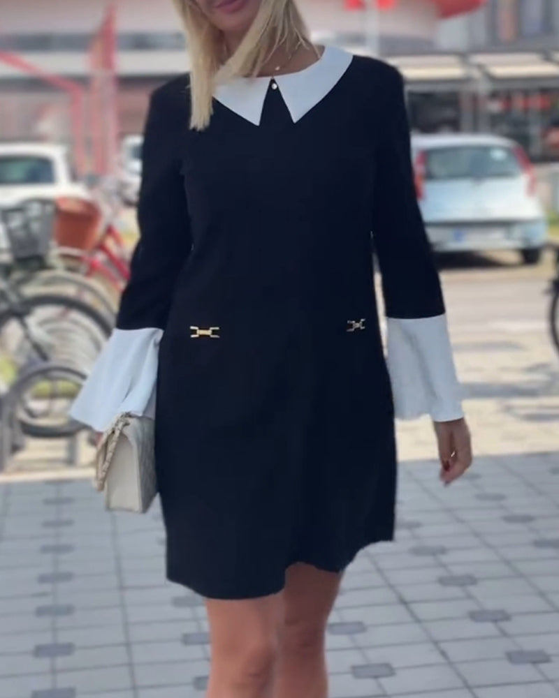 Elegantes kleid mit kontrastierendem revers und glockenärmeln